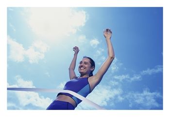 SuperStock_1166R_4753_Low_Angle_View_of_a_Female_Athlete_Crossing_the_Finishing_Line_Posters.jpg