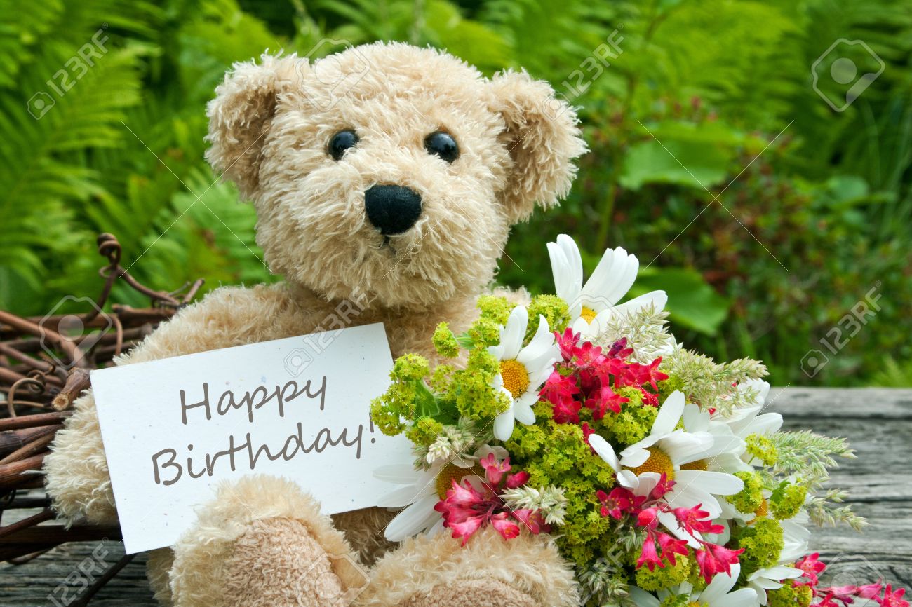 21133188_teddy_bear_with_flowers_and_birthday_card_Stock_Photo.jpg
