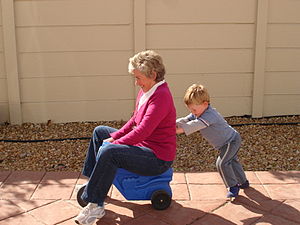 300px_Child_pushing_grandmother_on_plastic_tricycle.jpg