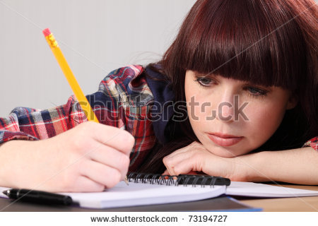 stock_photo_beautiful_young_caucasian_student_girl_at_home_sitting_to_her_desk_with_chin_resting_on_hands_73194727.jpg