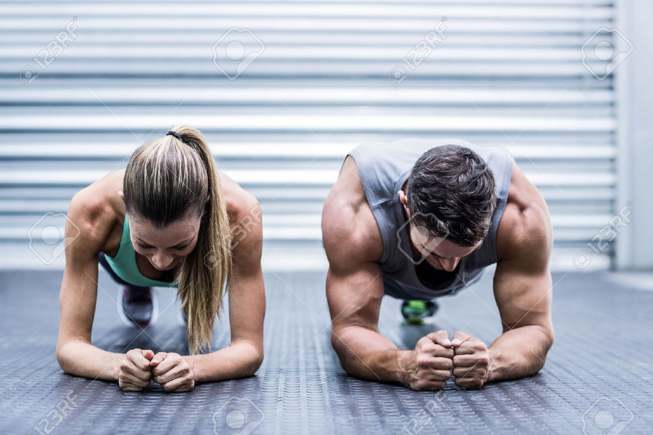 42329549_Front_view_of_a_muscular_couple_doing_planking_exercises_Stock_Photo.jpg