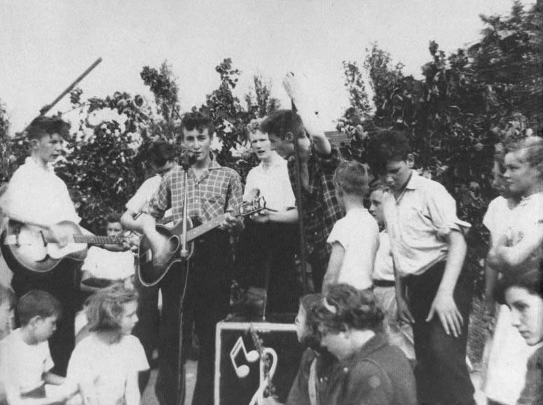 1957_July_6___The_Quarrymen_perform_at_the_Woolton_Parish_Church_Fete.jpg