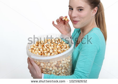 stock_photo_woman_eating_popcorn_from_large_bucket_102592652.jpg