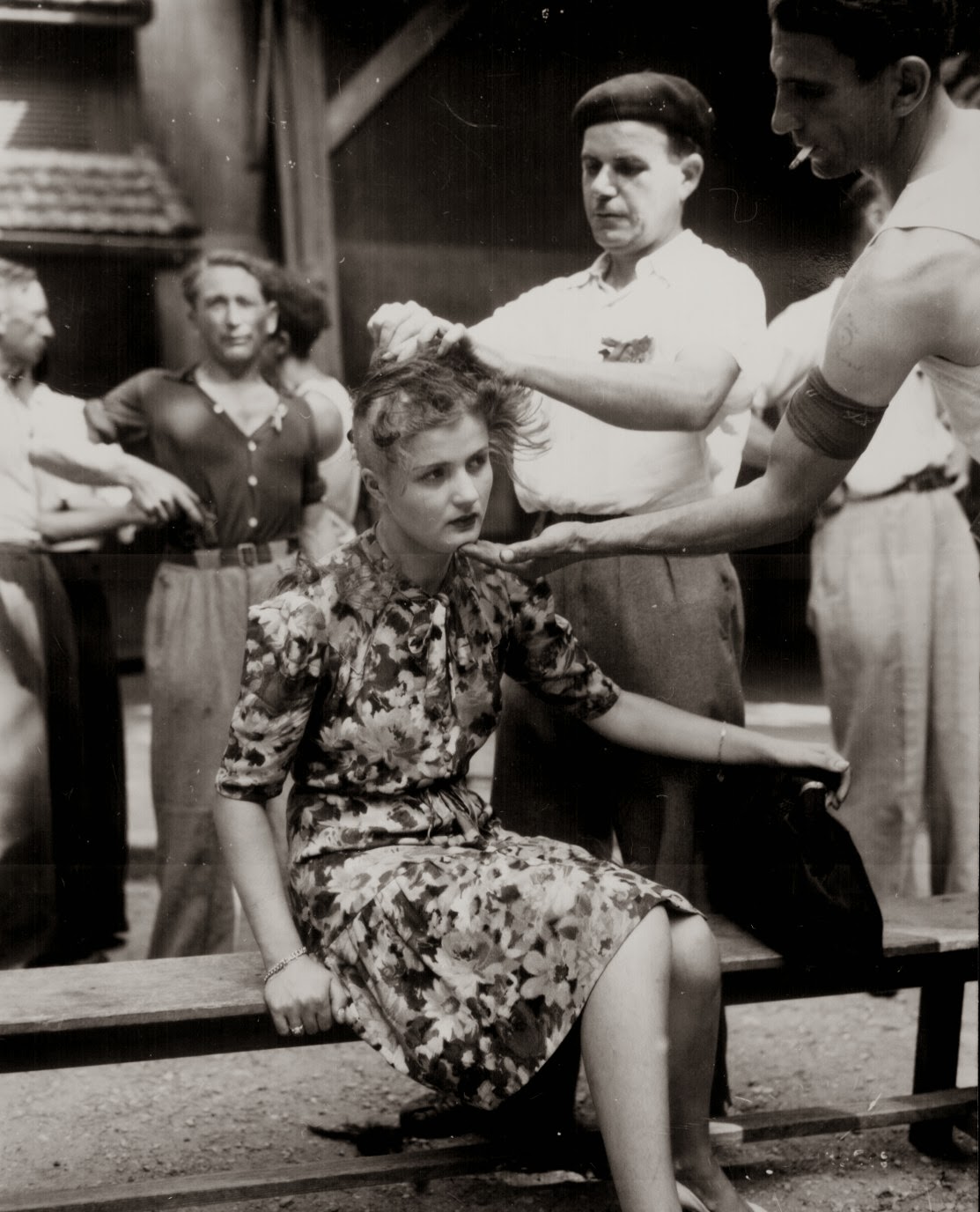A_French_woman_has_her_head_shaved_by_civilians_as_a_penalty_for_having_consorted_with_German_troops__1944.jpg