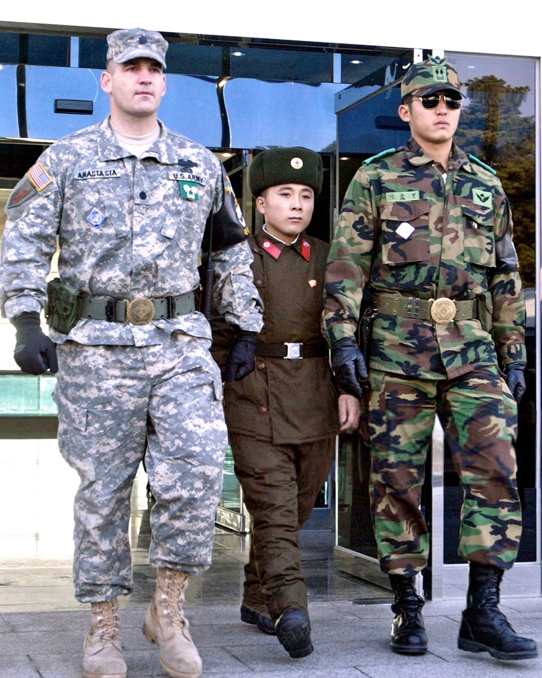 repatriated_north_korean_soldier_walking_in_between_an_v0_ecu2g2tqui1c1.jpg