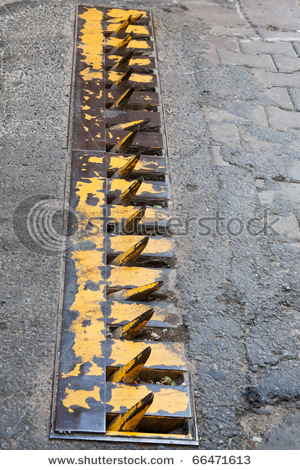 09cf9_stock_photo_road_spike_strip_on_street_66471613.jpg
