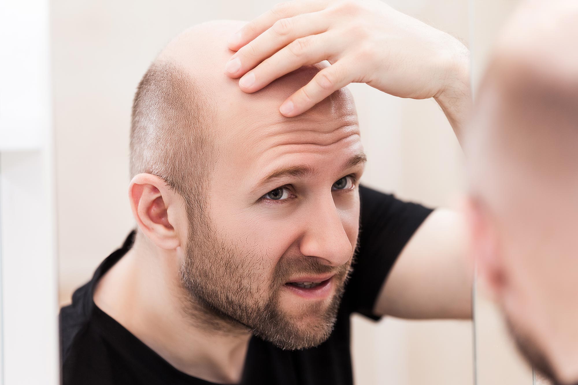 Bald_Man_Looking_at_Mirror.jpg
