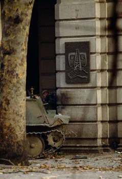 Soldier_20Hiding_20Behind_20Personnel_20Carrier_20in_20Tbilisi.jpg