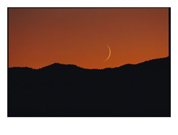 A_crescent_moon_sets_over_mountains_rimming_the_western_edge_of_Lake_Tahoe_Photographic_Print_C11892797.jpeg