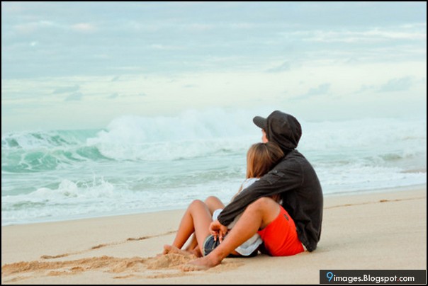 couple_hug_sitting_on_beach.jpg