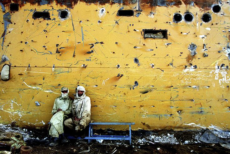 Two_workers_take_a_short_break_while_welding_inside_a_ship___s_hull_at_the_Gaddani_ship_breaking_yard__Pakistan___by_G.M.B._Akash__1977___Bangladeshi.jpg