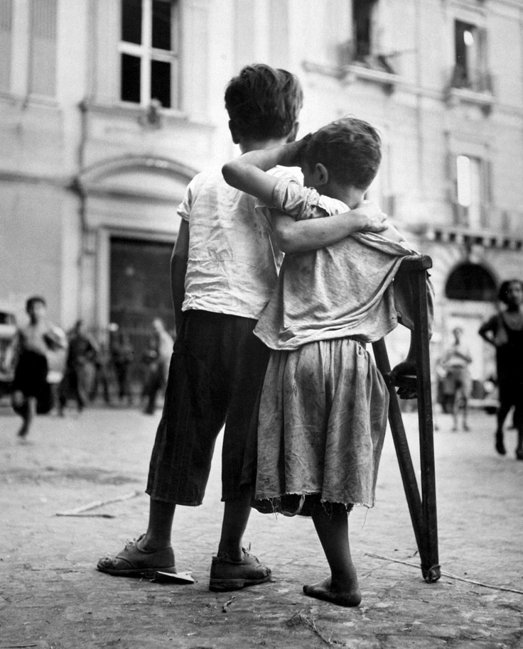 Boy_Helps_Amputee_Friend_Injured_in_War_in_Naples__Italy_by_Henri_Cartier_Bresson_1944.jpg