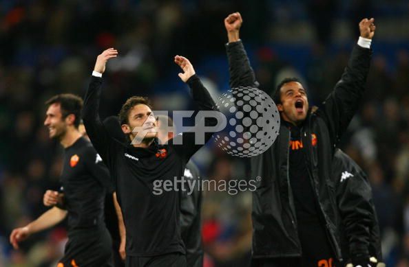 Roma__s_Francesco_Totti__L__and_Mancini_Faiolhe__R__celebrate_after_beating_Real_Madrid_in_a_Champions_league_return_leg_football_match_at_the_Santiago_Bernabeu_stadium_in_Madrid_on_March_5.jpg