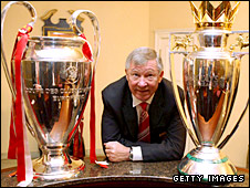 Sir_Alex_Ferguson_with_Two_Trophies.jpg