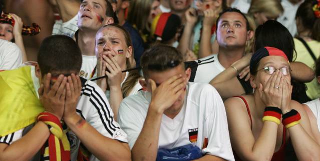 German_soccer_fans_cry_during_public_viewing_on_the_so_called_fan_mile_in_Berlin_following_their_teams_0_2_defeat_in_the_World_Cup_2006_semi_final_against_Italy_in_Dortmund_July_4_2006.jpeg