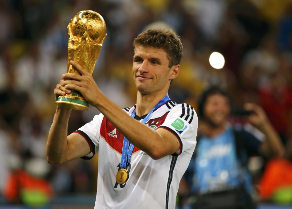449188_germanys_thomas_mueller_holds_up_the_trophy_after_winning_the_2014_wor2.jpg