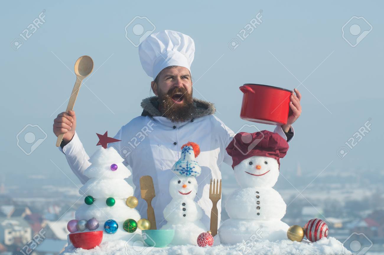 89626127_excited_man_holding_spoon_and_red_pot_cook_snowmen_and_snow_xmas_tree_on_blue_sky_christmas_and_new_.jpg