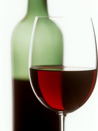 lehmann_joerg_red_wine_glass_with_half_full_wine_bottle_in_background.jpg