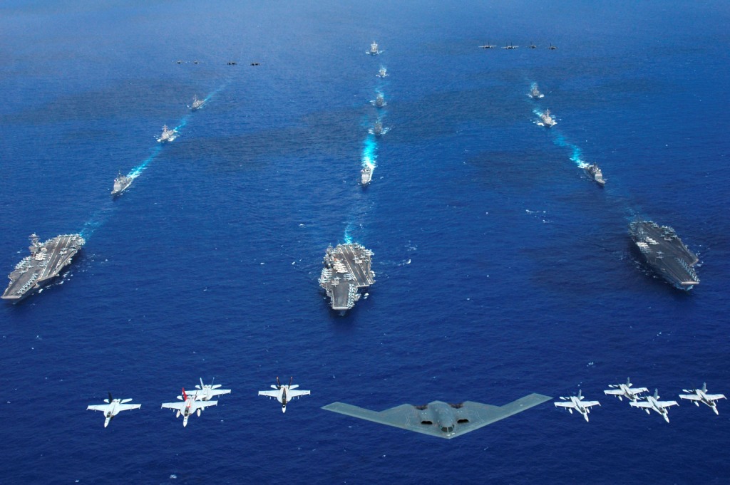 US_Navy_060618_N_8492C_212_An_Air_Force_B_2_bomber_along_with_other_aircrafts_from_the_Air_Force__Navy_and_Marine_Corps_fly_over_the_Kitty_Hawk__Ronald_Reagan_and_Abraham_Lincoln_Carrier_Strike_groups.jpg