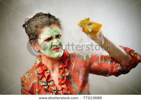 stock_photo_housewife_wearing_a_beauty_mask_and_a_dressing_gown_and_cleaning_77213689.jpg