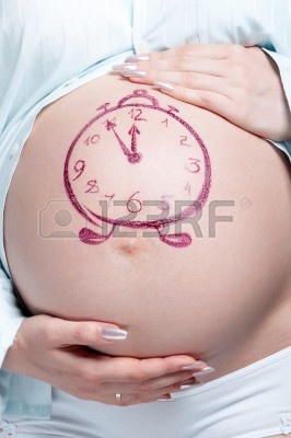 10387024_tummy_of_pregnant_woman_with_funny_drawing_over_white_background.jpg